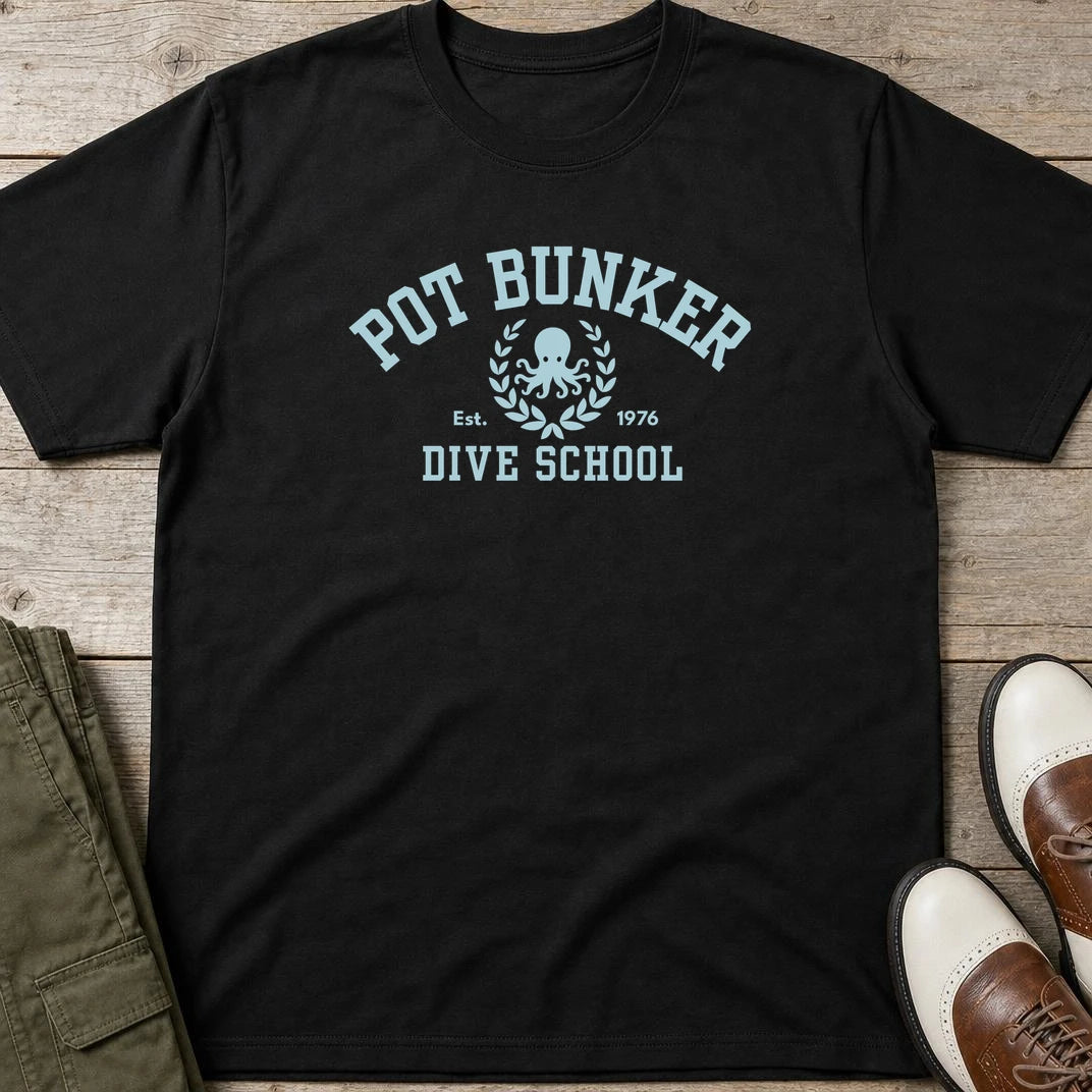 Pot Bunker T-Shirt in Black lying on a plain floor. T-shirt is a unisex cut and 100 per cent cotton.