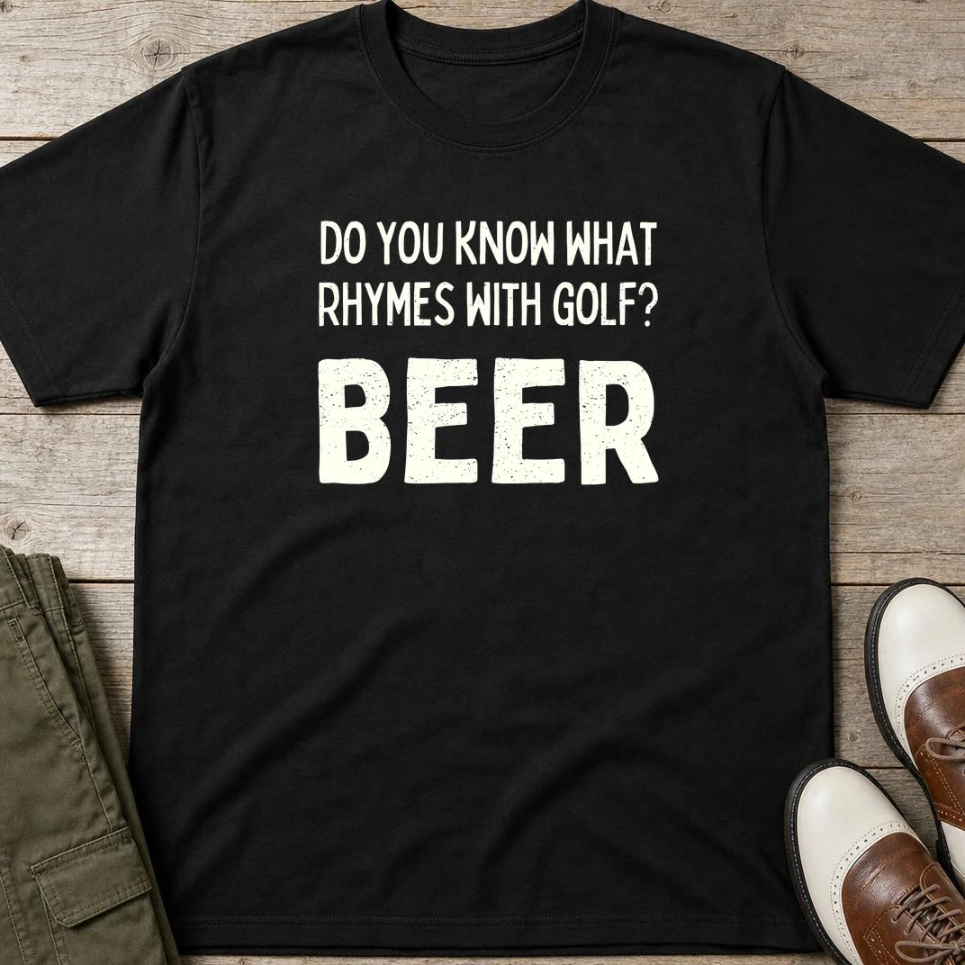 Rhymes With Golf T-Shirt in Black lying on a plain floor. T-shirt is a unisex cut and 100 per cent cotton.