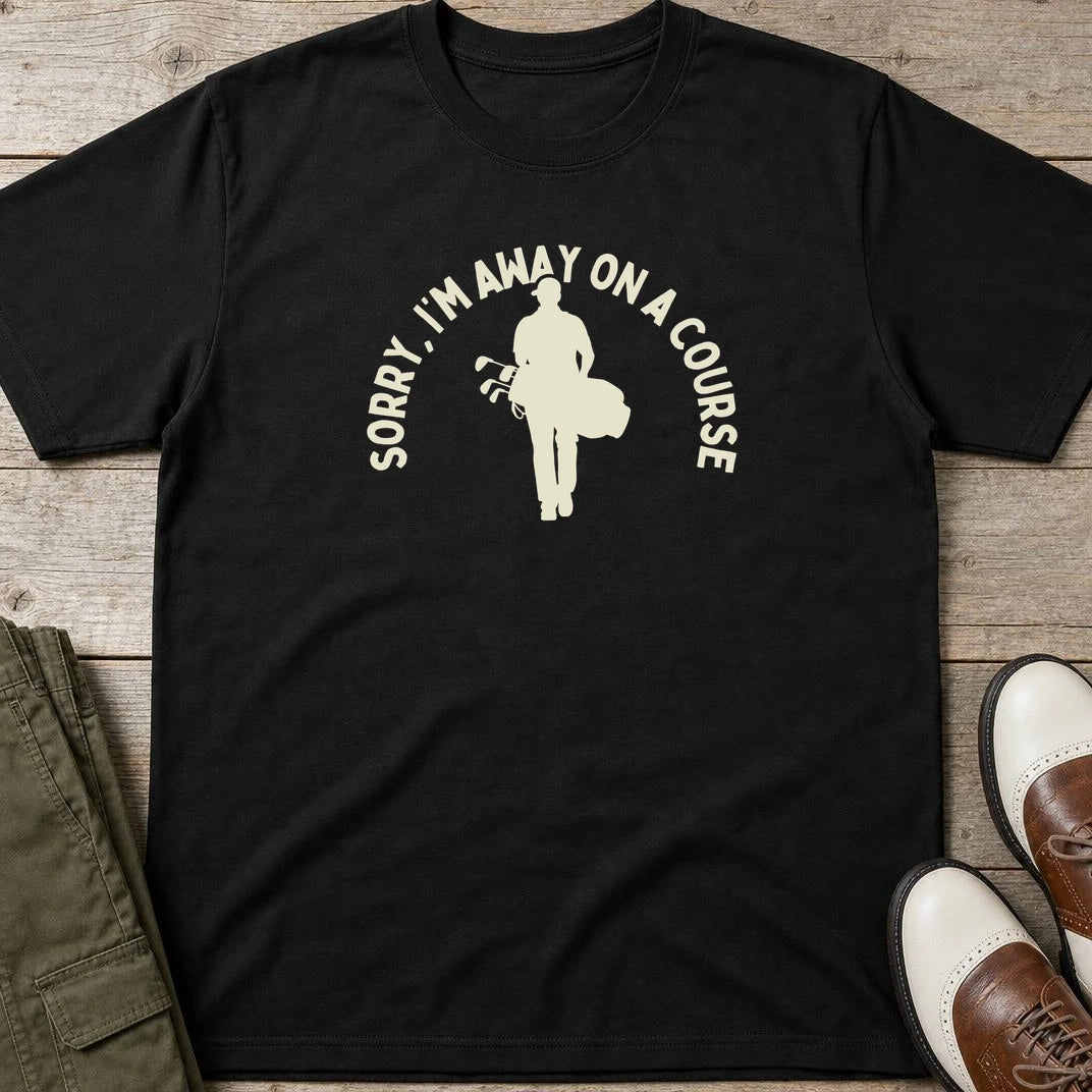 On A Course T-Shirt in Black lying on a plain floor. T-shirt is a unisex cut and 100 per cent cotton.