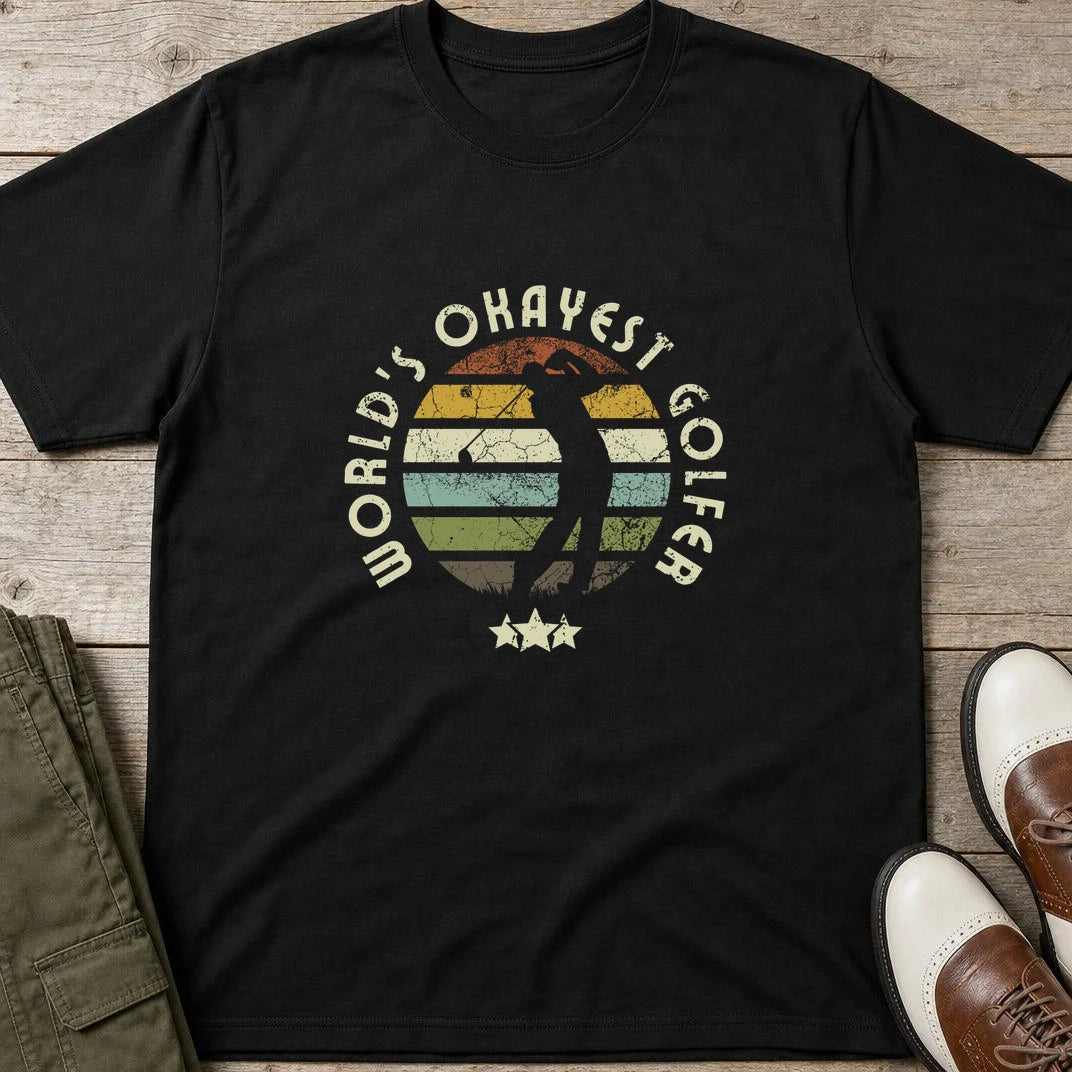 Okayest Golfer T-Shirt in Black lying on a plain floor. T-shirt is a unisex cut and 100 per cent cotton.