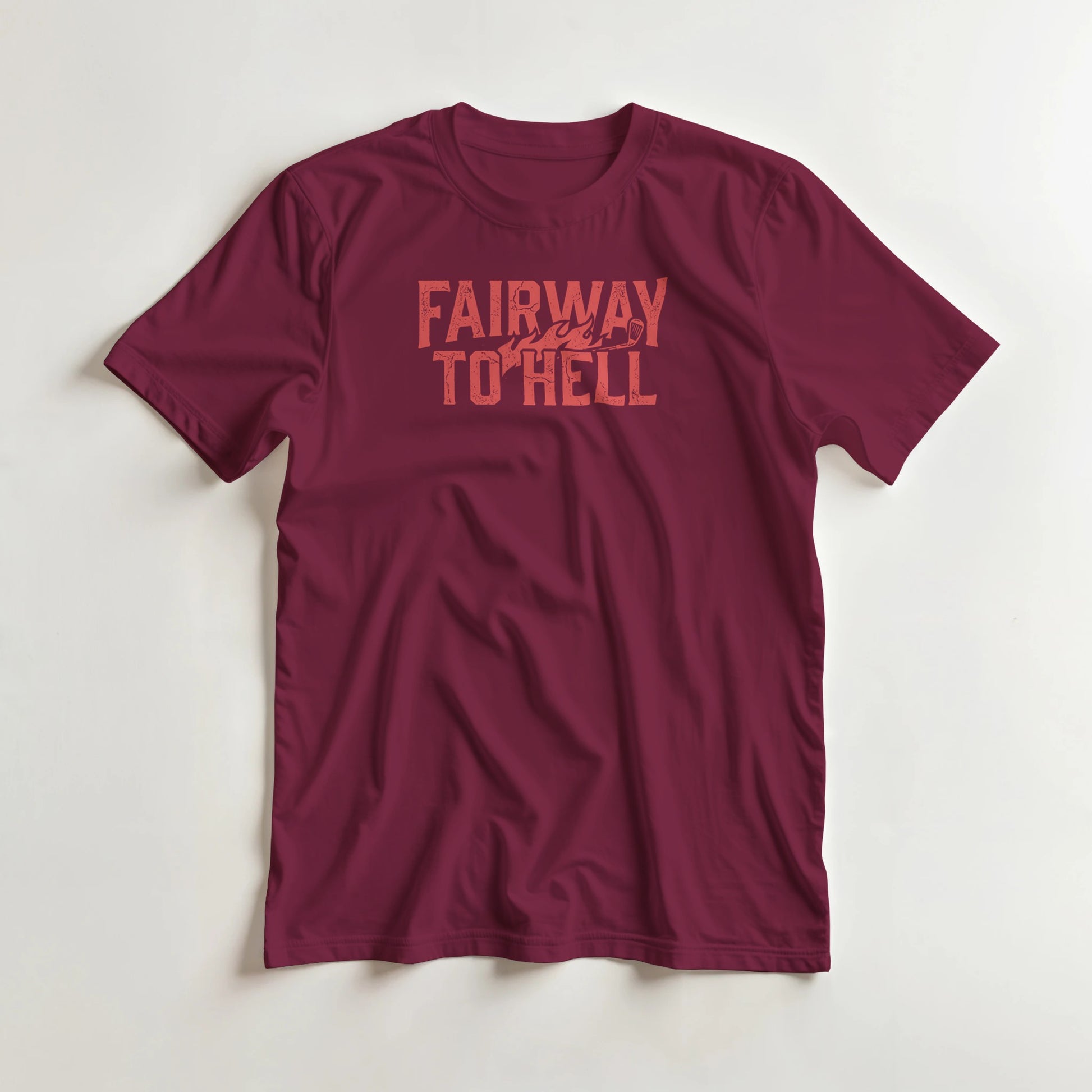 Fairway To Hell II T-Shirt in Maroon S lying on a plain floor. T-shirt is a unisex cut and 100 per cent cotton.