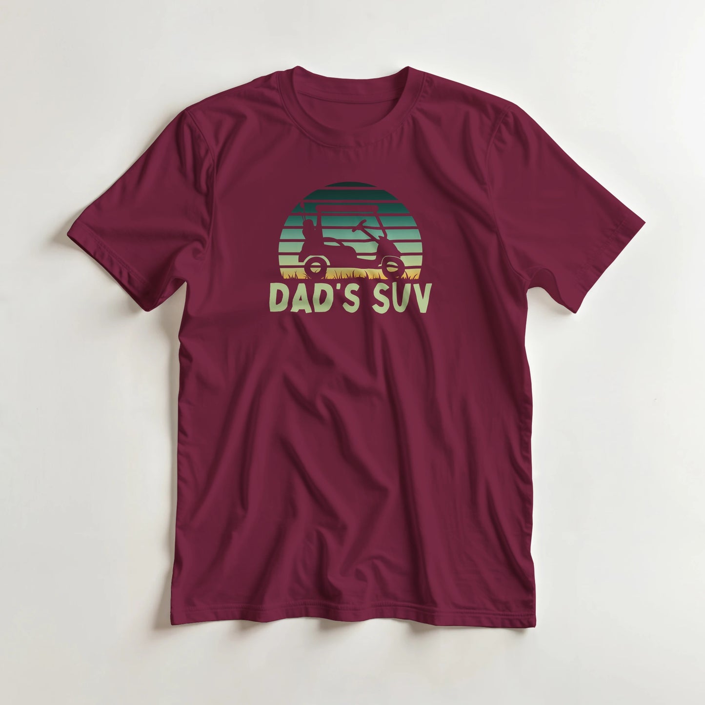 Dad's SUV T-Shirt in Maroon lying on a plain floor. T-shirt is a unisex cut and 100 per cent cotton.