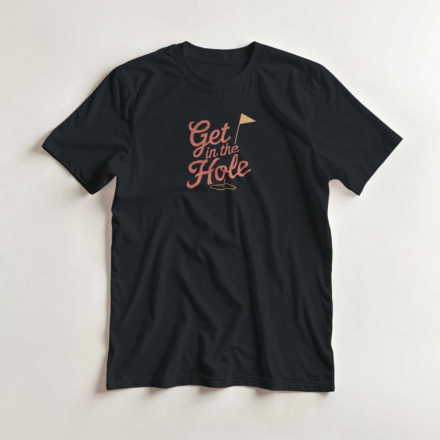 In The Hole T-Shirt in Black XL lying on a plain floor. T-shirt is a unisex cut and 100 per cent cotton.