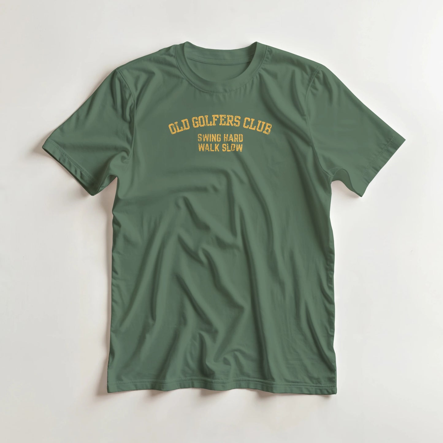 Old Golfers T-Shirt in Military Green lying on a plain floor. T-shirt is a unisex cut and 100 per cent cotton.