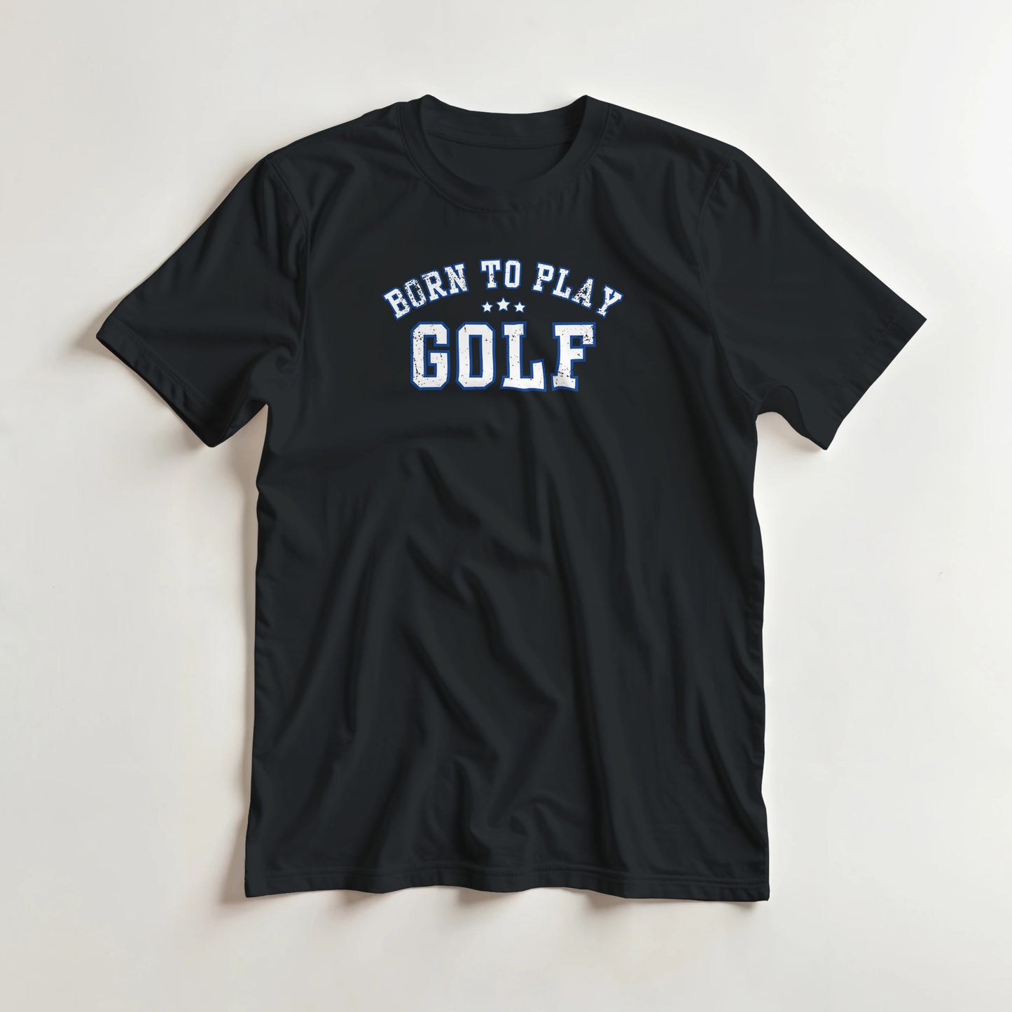 Born To Play Golf T-Shirt in Black lying on a plain floor. T-shirt is a unisex cut and 100 per cent cotton.