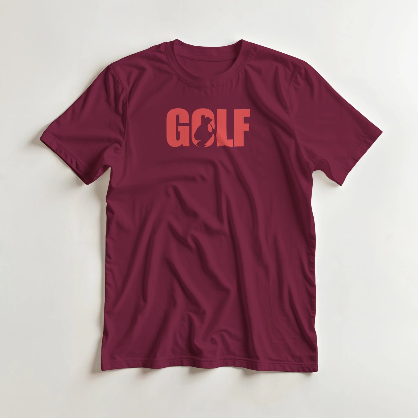 Golf C T-Shirt in Maroon lying on a plain floor. T-shirt is a unisex cut and 100 per cent cotton.