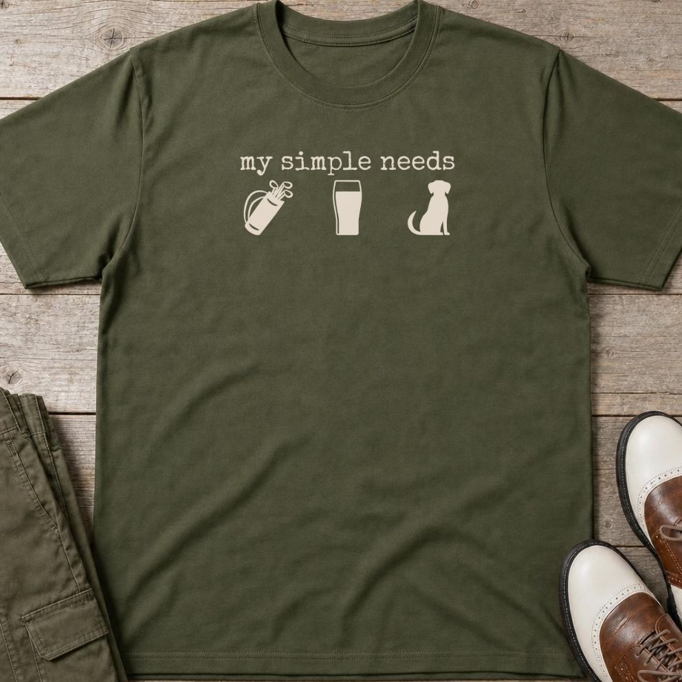 Simple Needs T-Shirt in Military Green lying on a plain floor. T-shirt is a unisex cut and 100 per cent cotton.