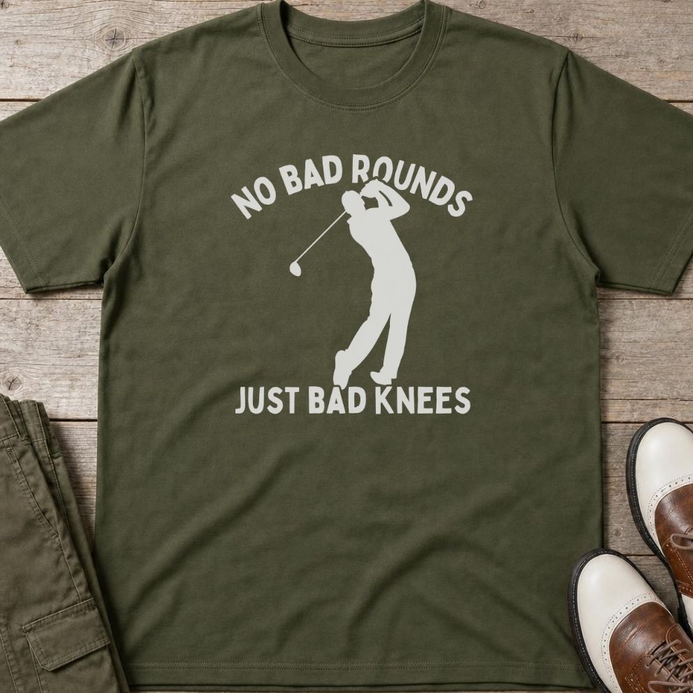 Bad Knees T-Shirt in Military Green lying on a plain floor. T-shirt is a unisex cut and 100 per cent cotton.