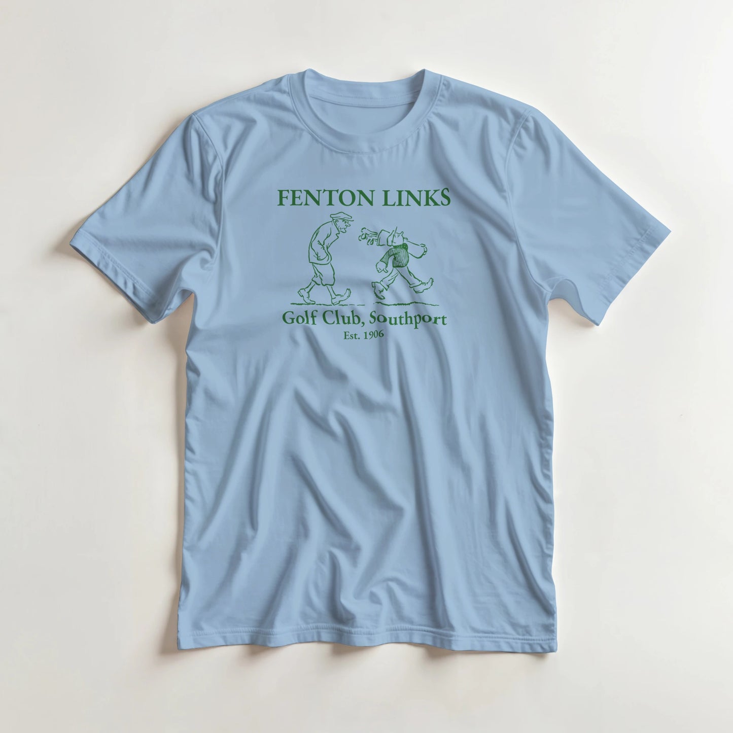 Fenton Links T-Shirt in Light Blue lying on a plain floor. T-shirt is a unisex cut and 100 per cent cotton.