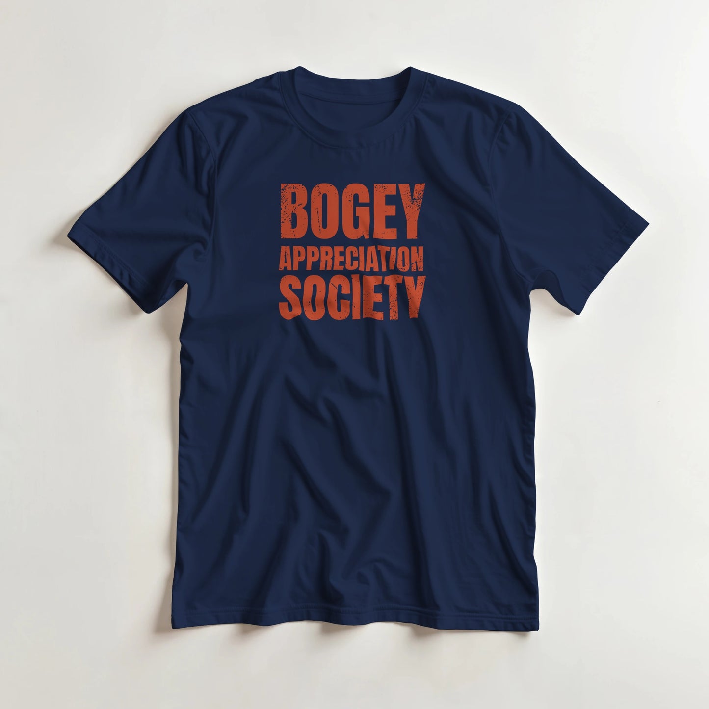 Bogey Appreciation T-Shirt in Navy L lying on a plain floor. T-shirt is a unisex cut and 100 per cent cotton.