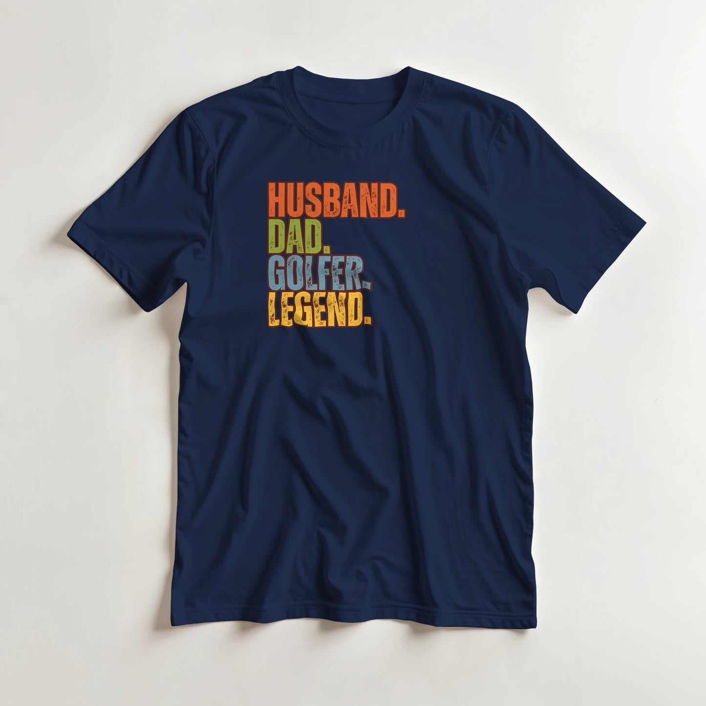 Husband Dad T-Shirt in Navy lying on a plain floor. T-shirt is a unisex cut and 100 per cent cotton.