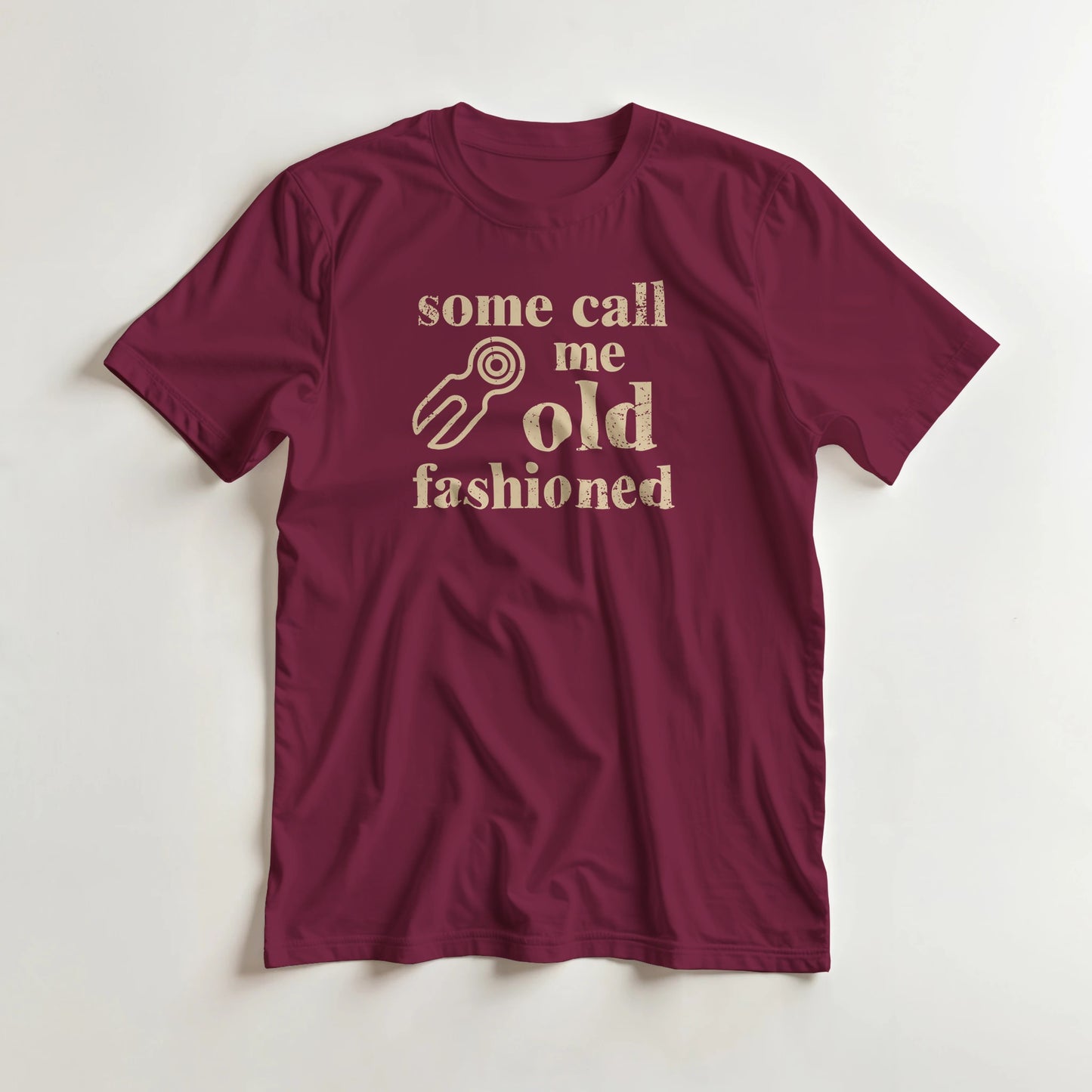 Old Fashioned T-Shirt in Maroon L lying on a plain floor. T-shirt is a unisex cut and 100 per cent cotton.