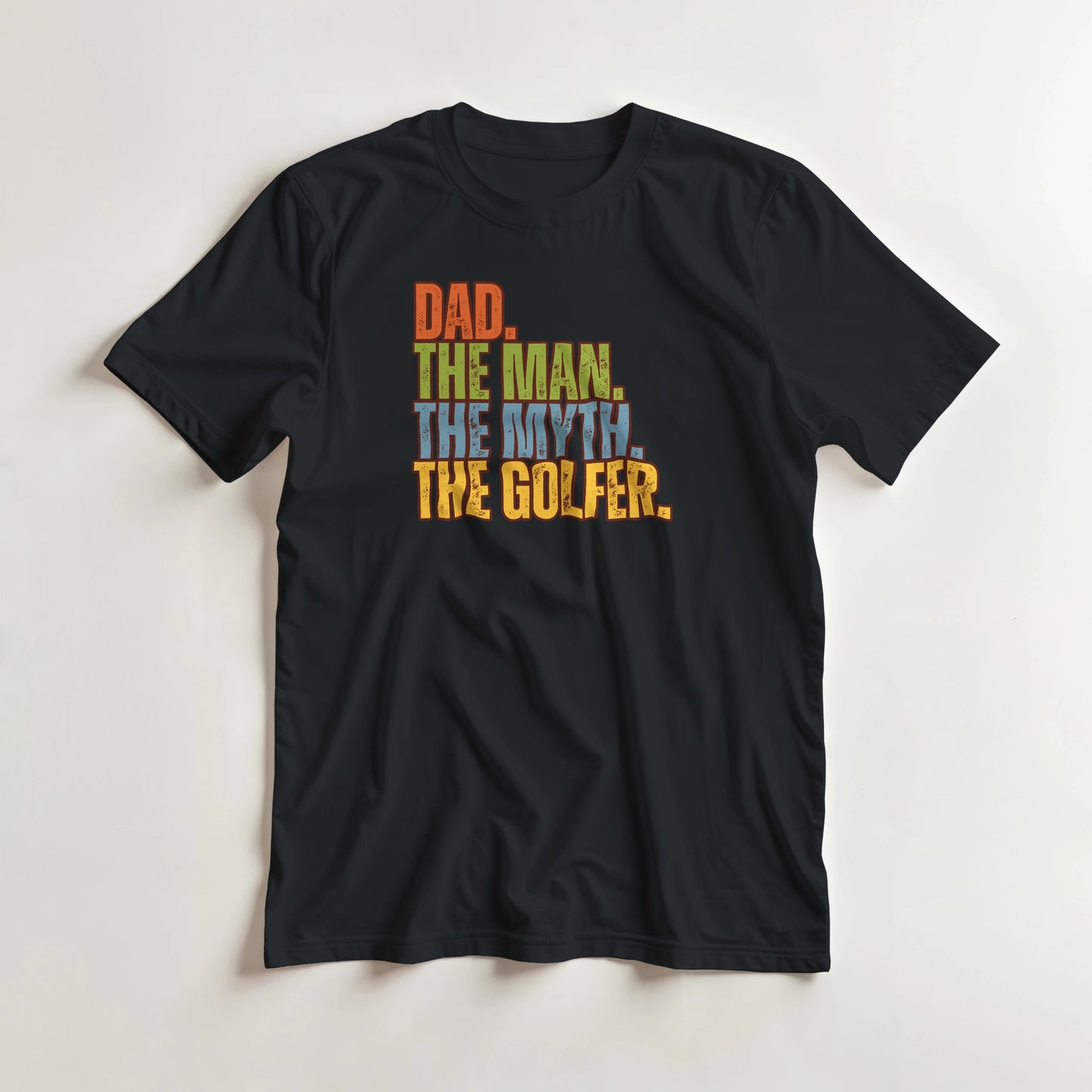 Dad The Legend Golfer T-Shirt in Black M lying on a plain floor. T-shirt is a unisex cut and 100 per cent cotton.