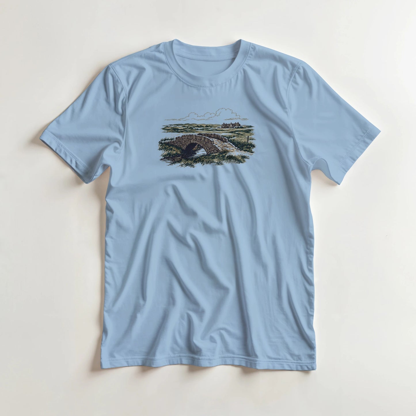The Burn T-Shirt in Light Blue lying on a plain floor. T-shirt is a unisex cut and 100 per cent cotton.