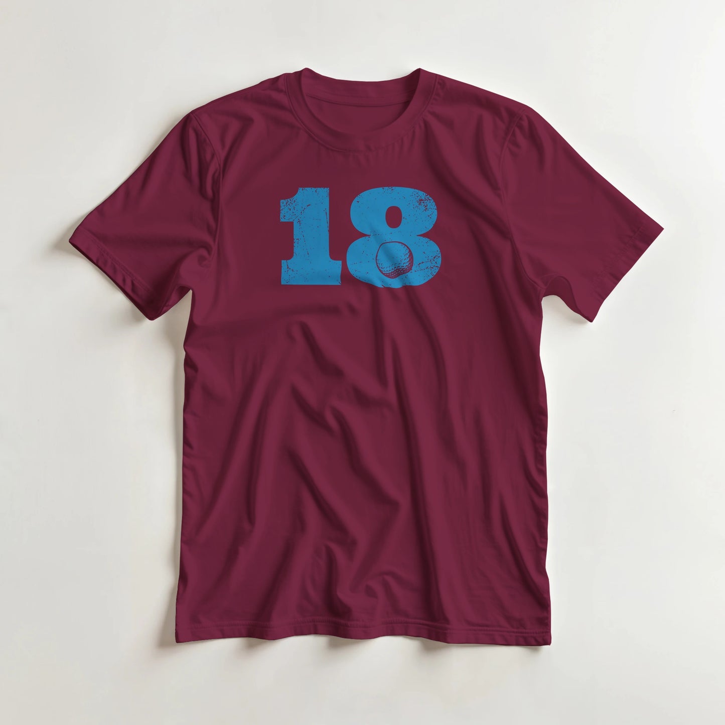 18 Golf T-Shirt in Maroon 3XL lying on a plain floor. T-shirt is a unisex cut and 100 per cent cotton.
