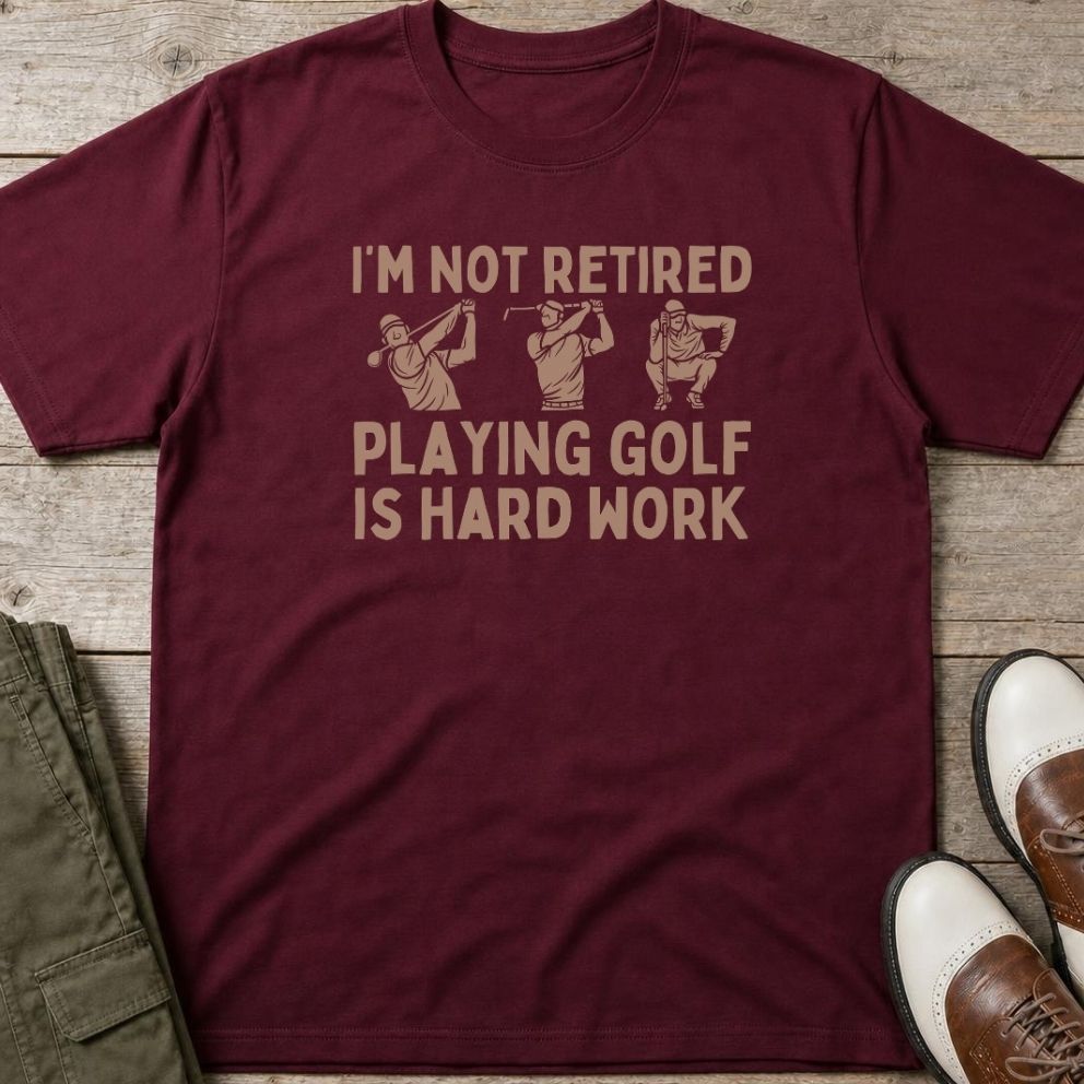 Hard Work T-Shirt in Maroon lying on a plain floor. T-shirt is a unisex cut and 100 per cent cotton.