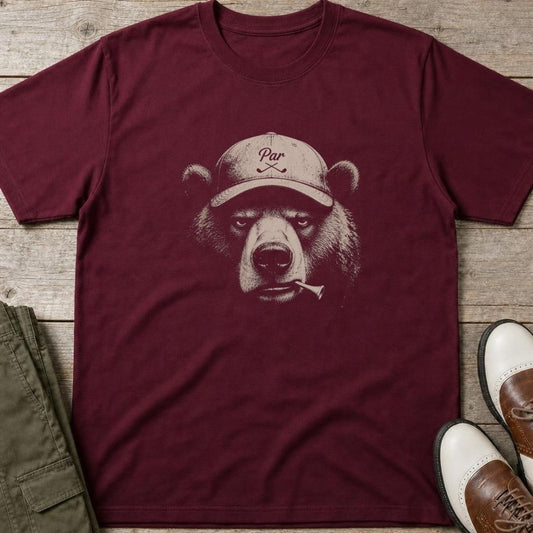Bear Golfer T-Shirt in Maroon lying on a plain floor. T-shirt is a unisex cut and 100 per cent cotton.