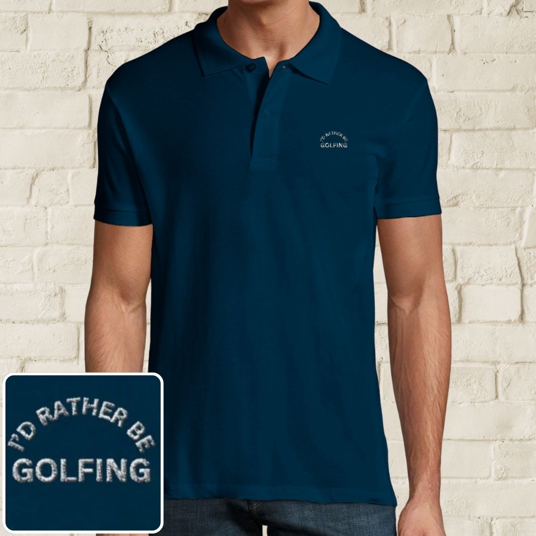 Rather Golfing Polo in Denim on a light wooden floor lying next to headphones and golf shoes.