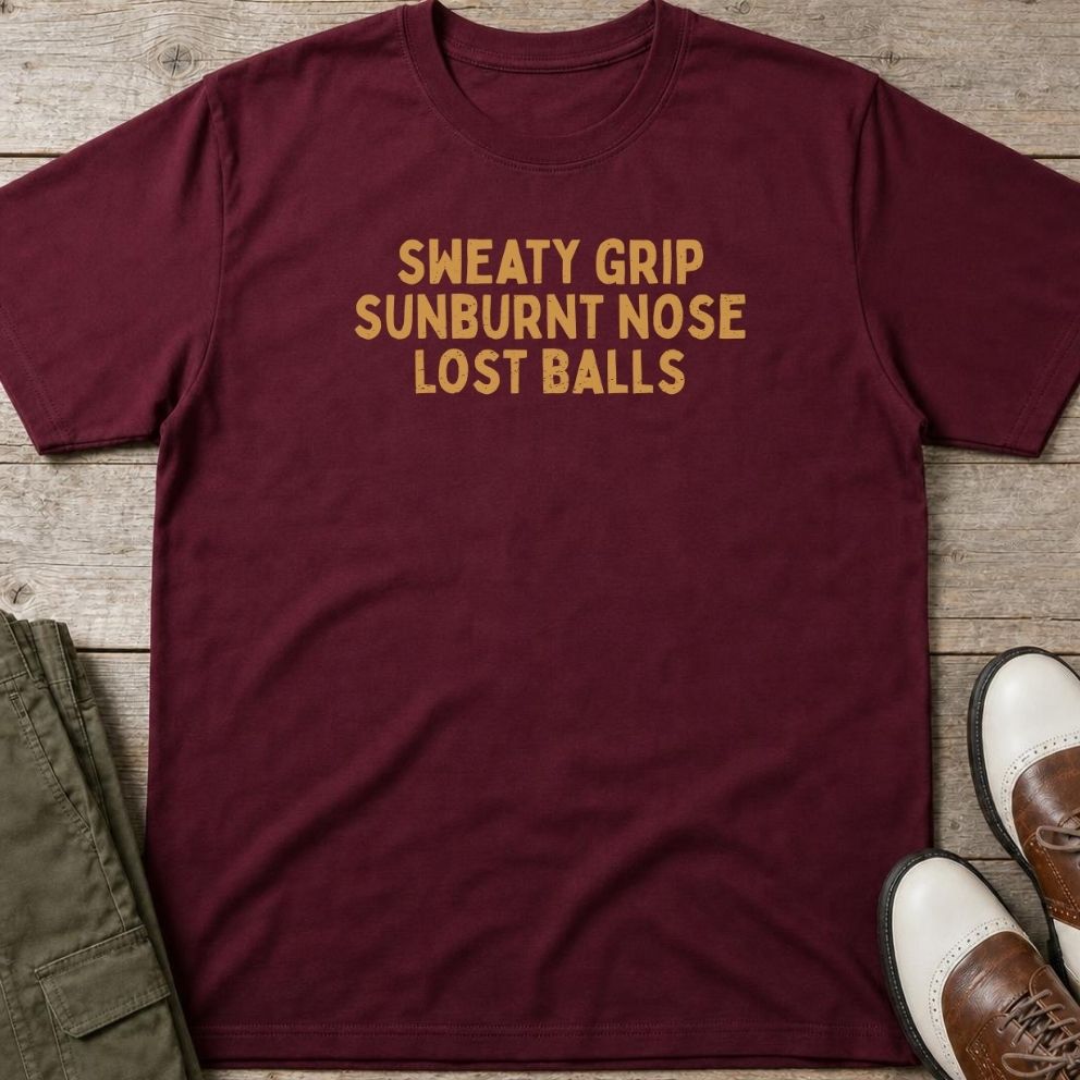 Sweaty Grip T-Shirt in Maroon lying on a plain floor. T-shirt is a unisex cut and 100 per cent cotton.