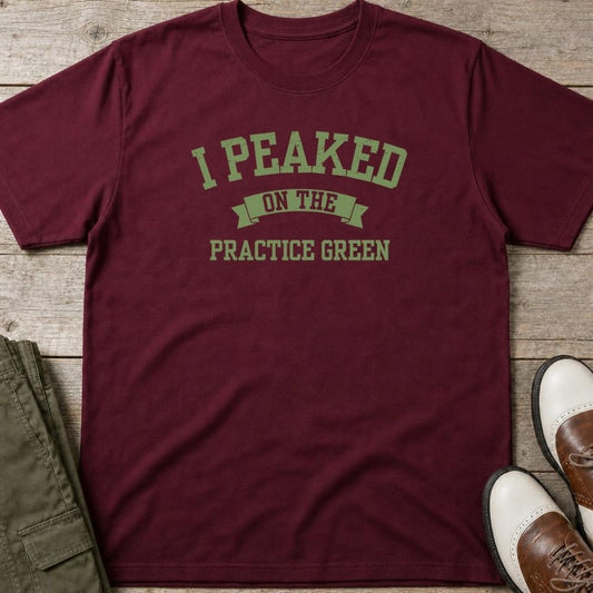 Practice Green T-Shirt in Maroon lying on a plain floor. T-shirt is a unisex cut and 100 per cent cotton.