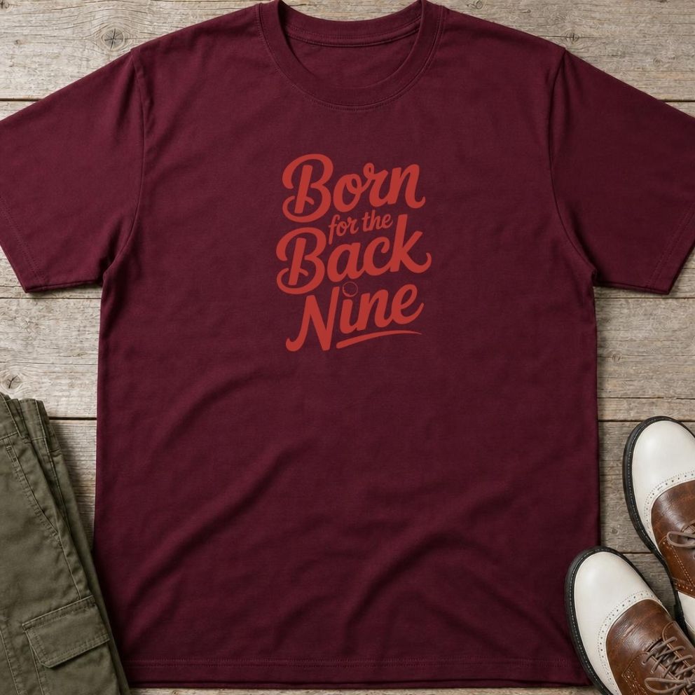 Back Nine T-Shirt in Maroon lying on a plain floor. T-shirt is a unisex cut and 100 per cent cotton.