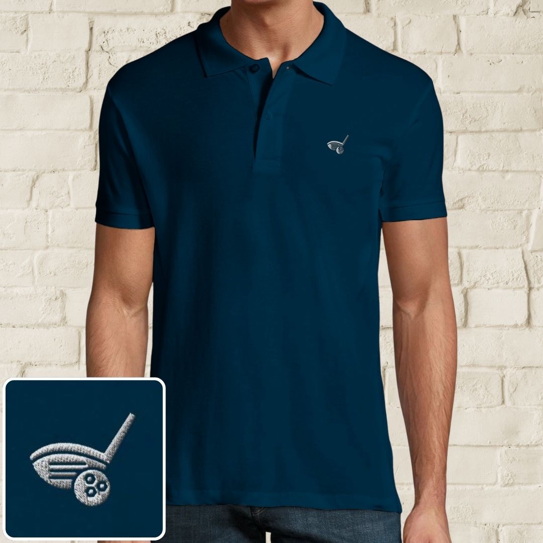 Driver Polo in Denim on a light wooden floor lying next to headphones and golf shoes.