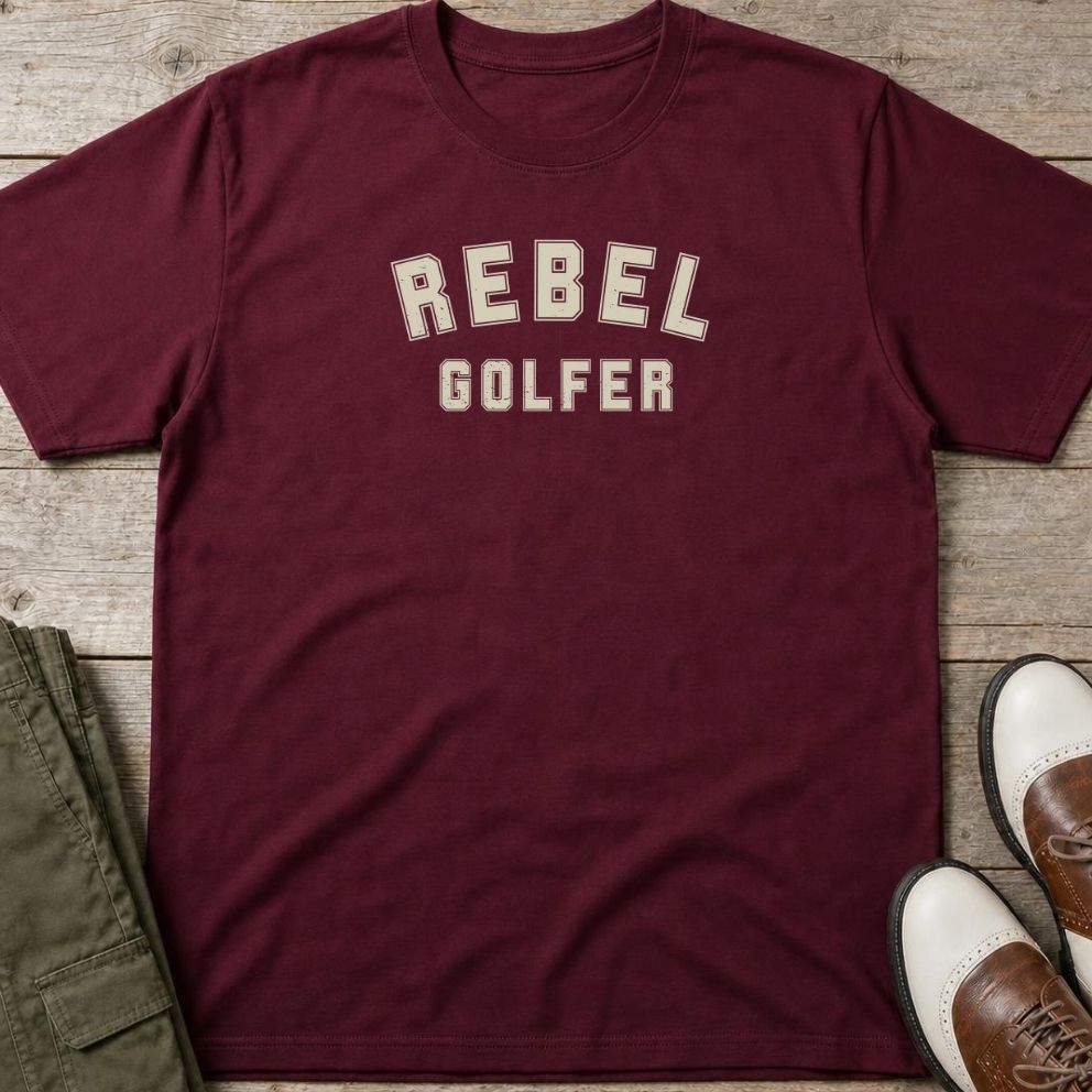 Rebel Golfer T-Shirt in Maroon lying on a plain floor. T-shirt is a unisex cut and 100 per cent cotton.
