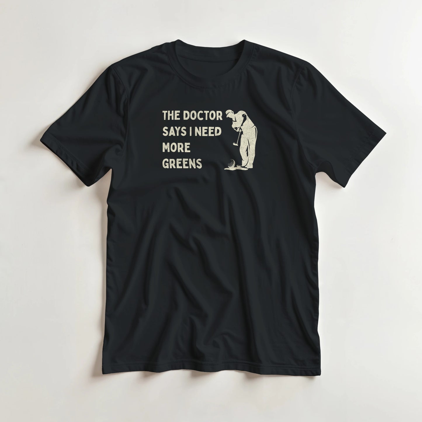 More Greens T-Shirt in Black lying on a plain floor. T-shirt is a unisex cut and 100 per cent cotton.