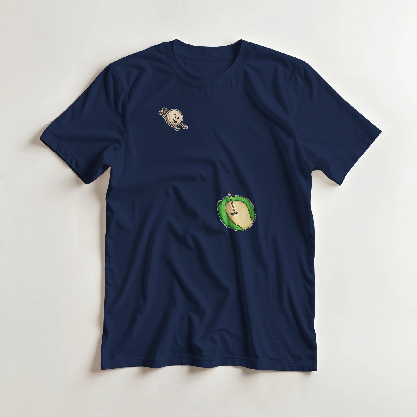 Flying Sand Trap T-Shirt in Navy lying on a plain floor. T-shirt is a unisex cut and 100 per cent cotton.