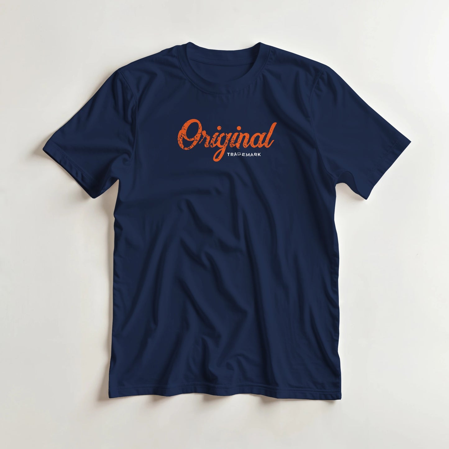 Original T-Shirt in Navy M lying on a plain floor. T-shirt is a unisex cut and 100 per cent cotton.