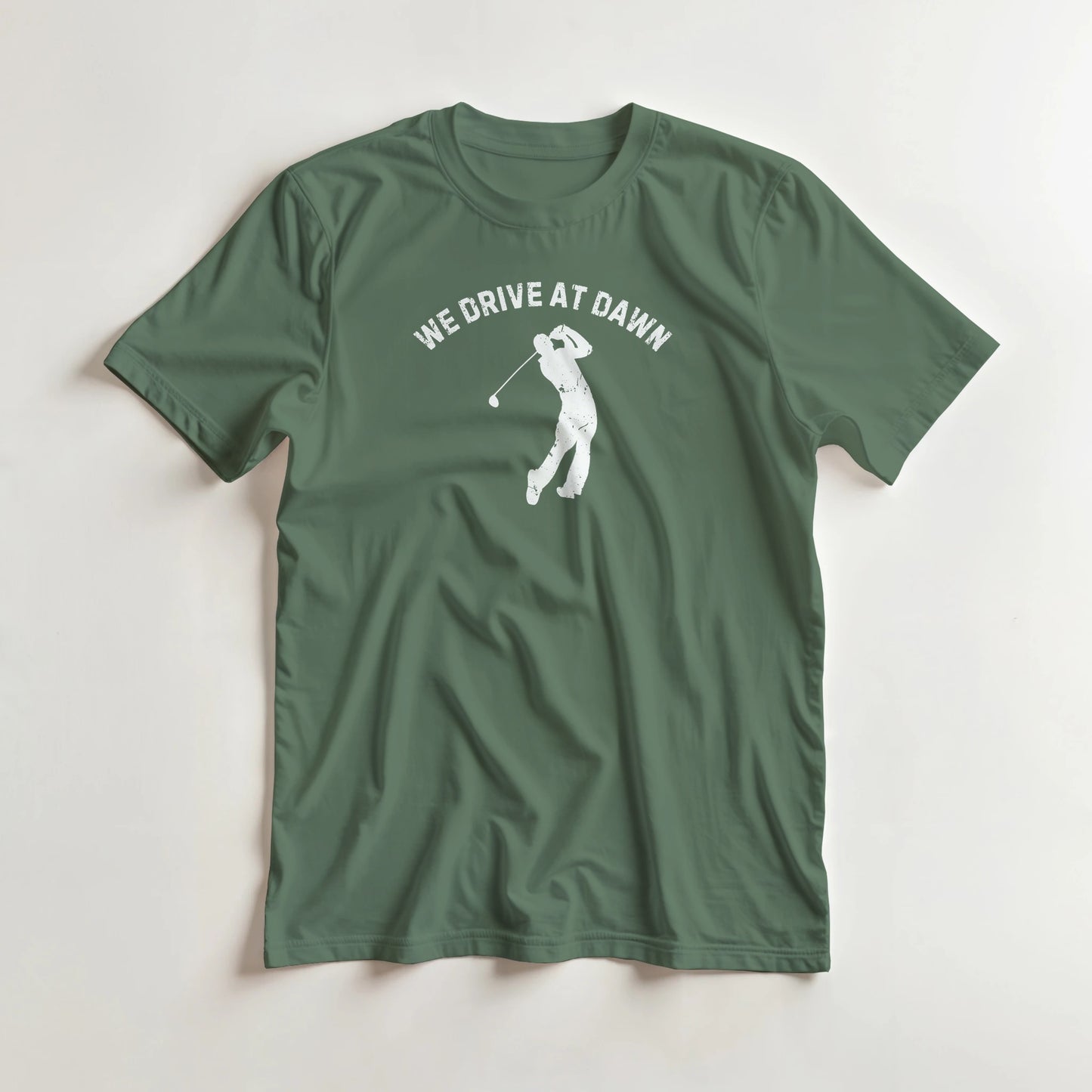 We Drive T-Shirt in Military Green L lying on a plain floor. T-shirt is a unisex cut and 100 per cent cotton.
