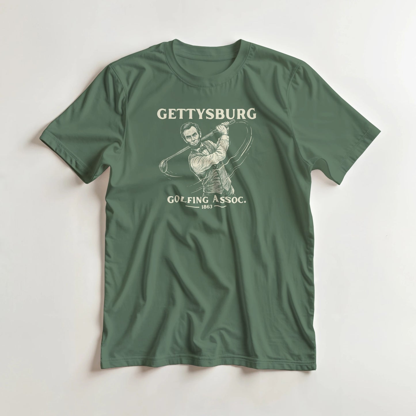 Gettysburg T-Shirt in Military Green lying on a plain floor. T-shirt is a unisex cut and 100 per cent cotton.