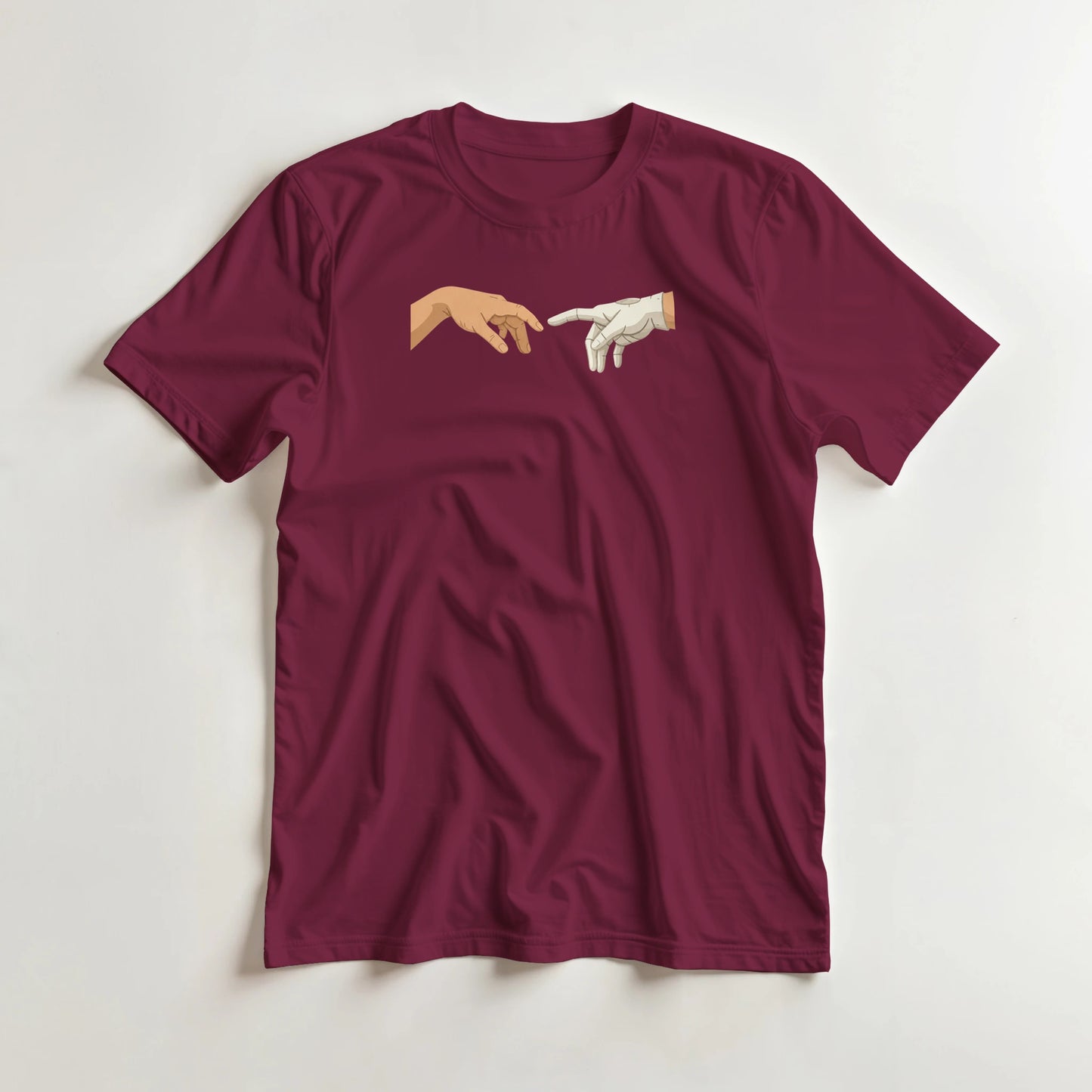 The Glove of God T-Shirt in Maroon lying on a plain floor. T-shirt is a unisex cut and 100 per cent cotton.