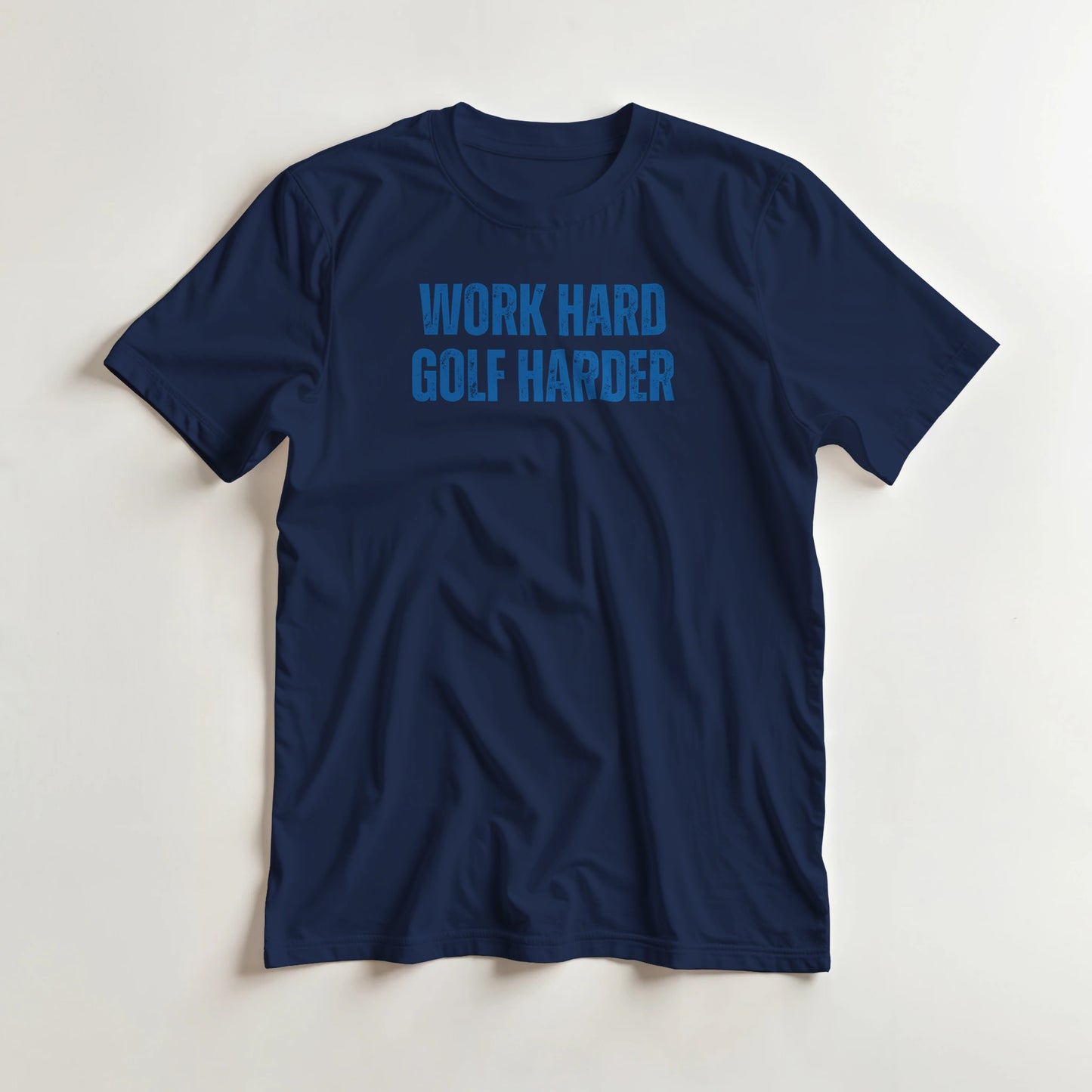 Golf Harder T-Shirt in Navy XL lying on a plain floor. T-shirt is a unisex cut and 100 per cent cotton.