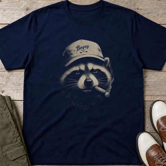 Raccoon Golfer T-Shirt in Navy lying on a plain floor. T-shirt is a unisex cut and 100 per cent cotton.