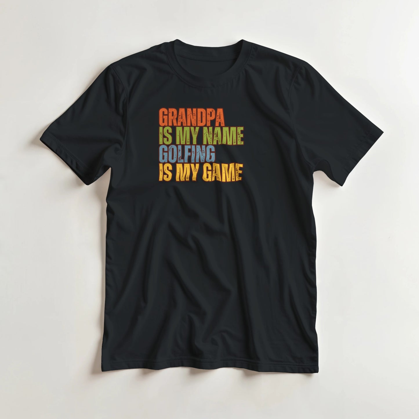 Grandpa Golfing T-Shirt in Black lying on a plain floor. T-shirt is a unisex cut and 100 per cent cotton.