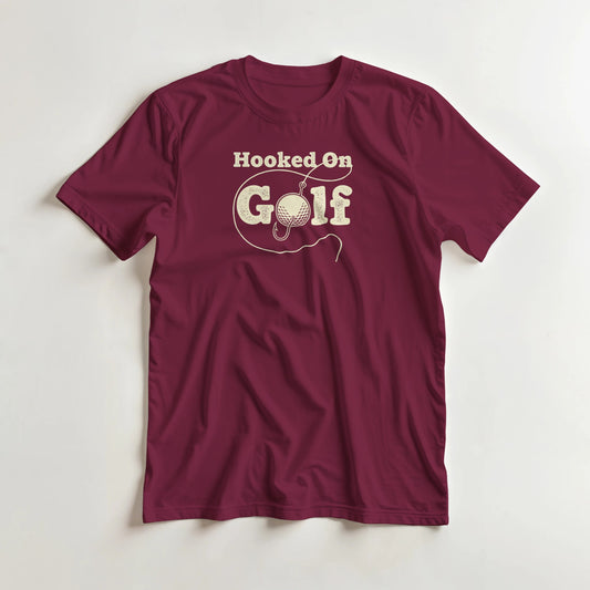 Hooked T-Shirt in Maroon lying on a plain floor. T-shirt is a unisex cut and 100 per cent cotton.
