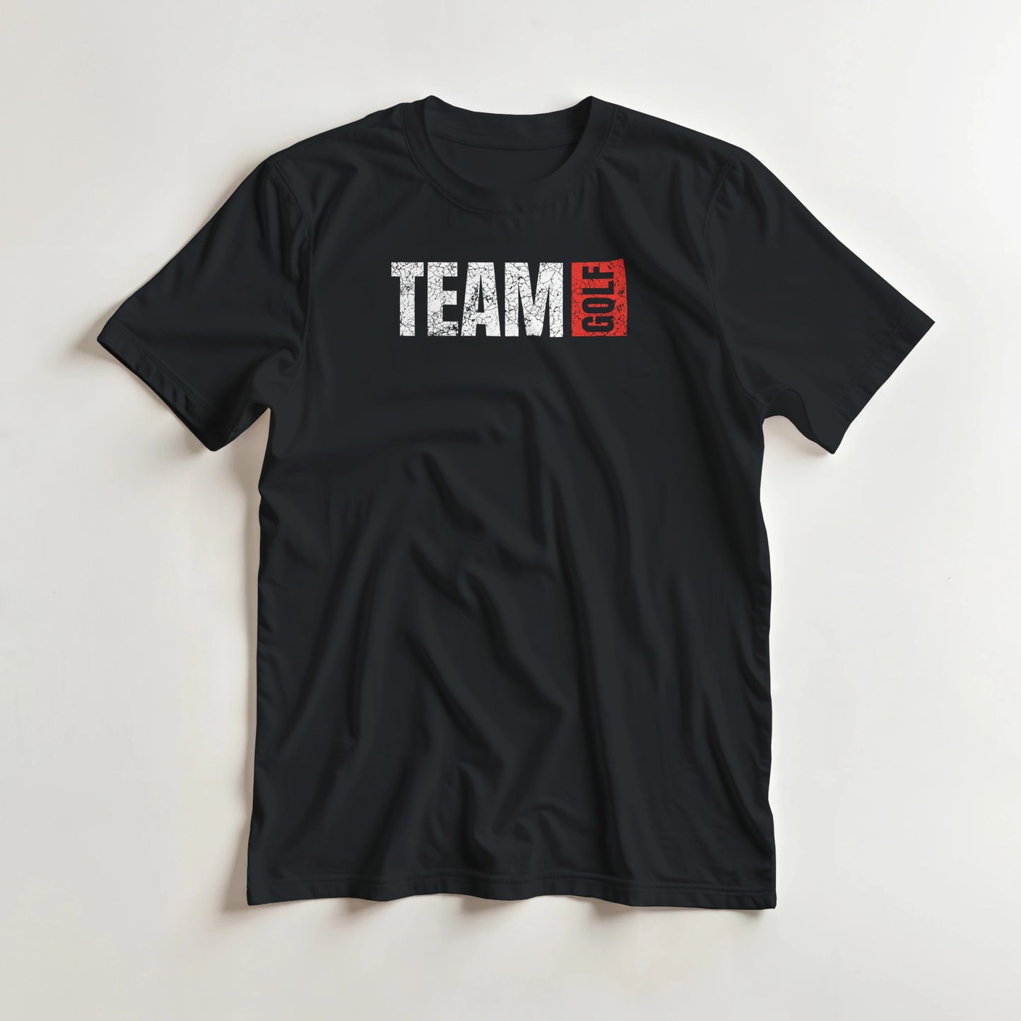 Team Golf T-Shirt in Black lying on a plain floor. T-shirt is a unisex cut and 100 per cent cotton.