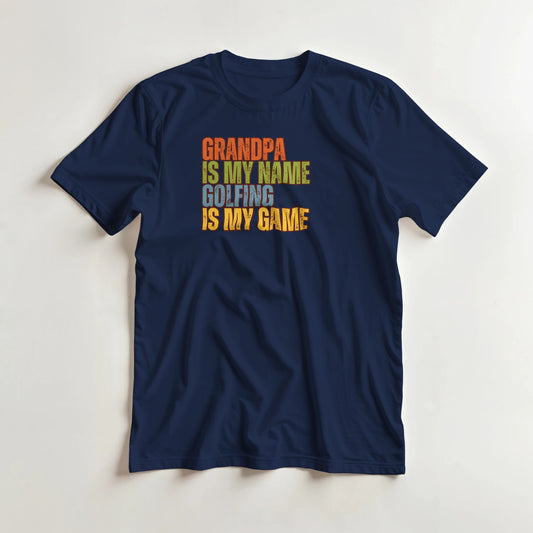 Grandpa Golfing T-Shirt in Navy lying on a plain floor. T-shirt is a unisex cut and 100 per cent cotton.