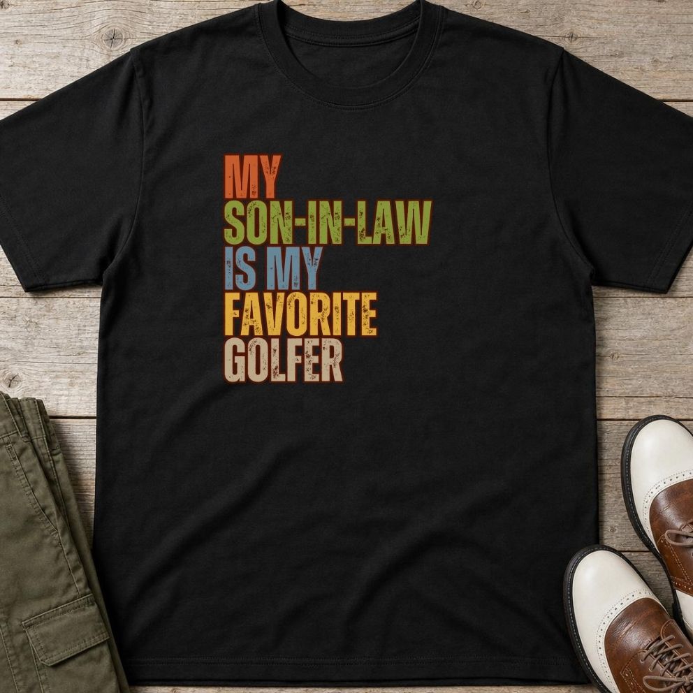 Son-In-Law T-Shirt in Black lying on a plain floor. T-shirt is a unisex cut and 100 per cent cotton.