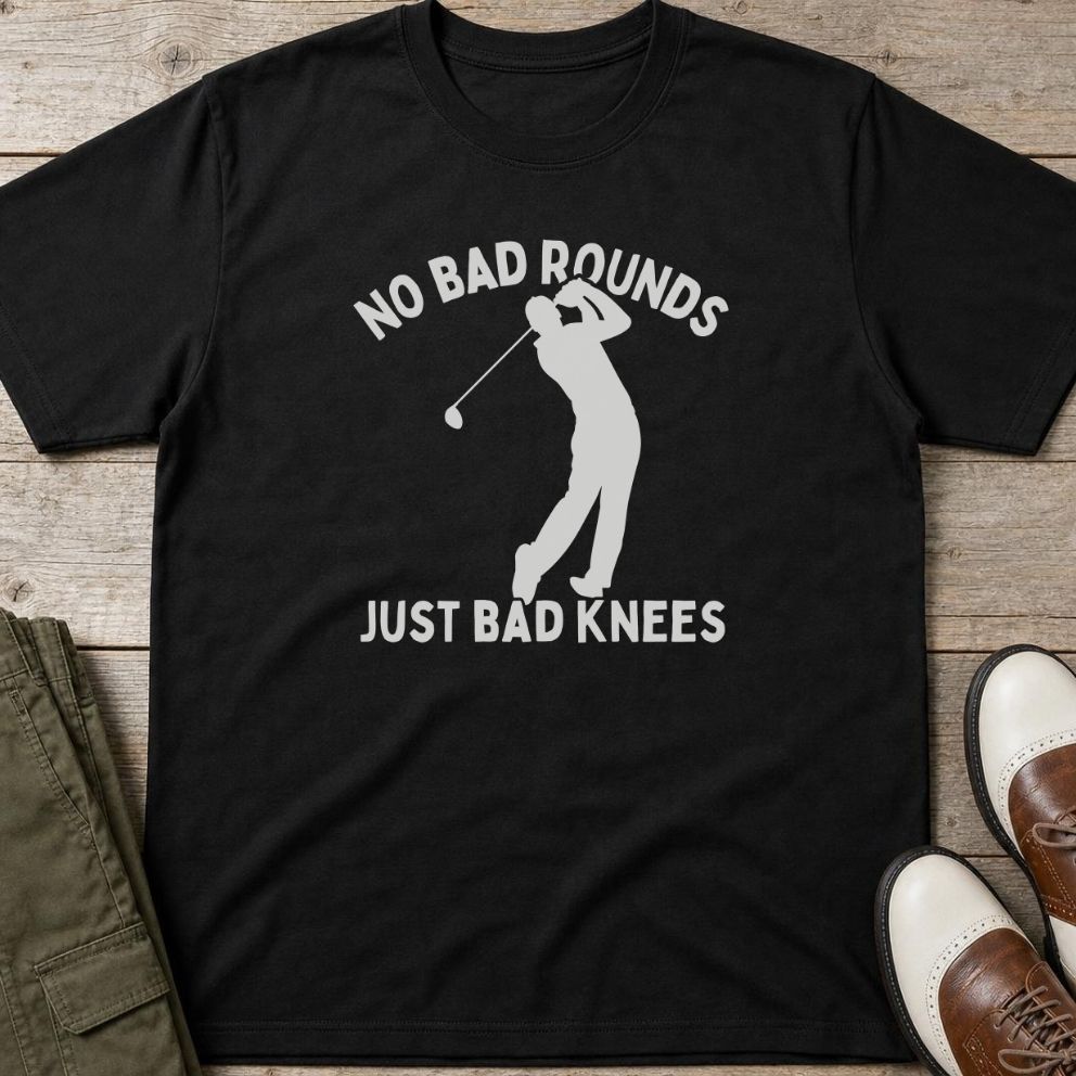 Bad Knees T-Shirt in Black lying on a plain floor. T-shirt is a unisex cut and 100 per cent cotton.