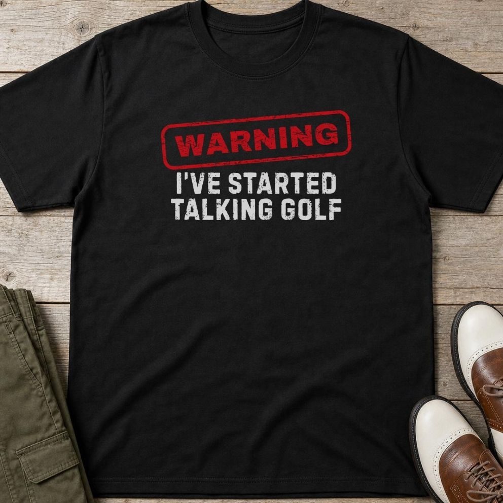 Talking Golf T-Shirt in Black lying on a plain floor. T-shirt is a unisex cut and 100 per cent cotton.