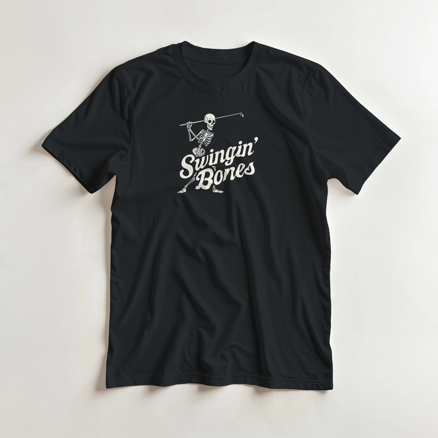 Swingin' Bones T-Shirt in Black L lying on a plain floor. T-shirt is a unisex cut and 100 per cent cotton.