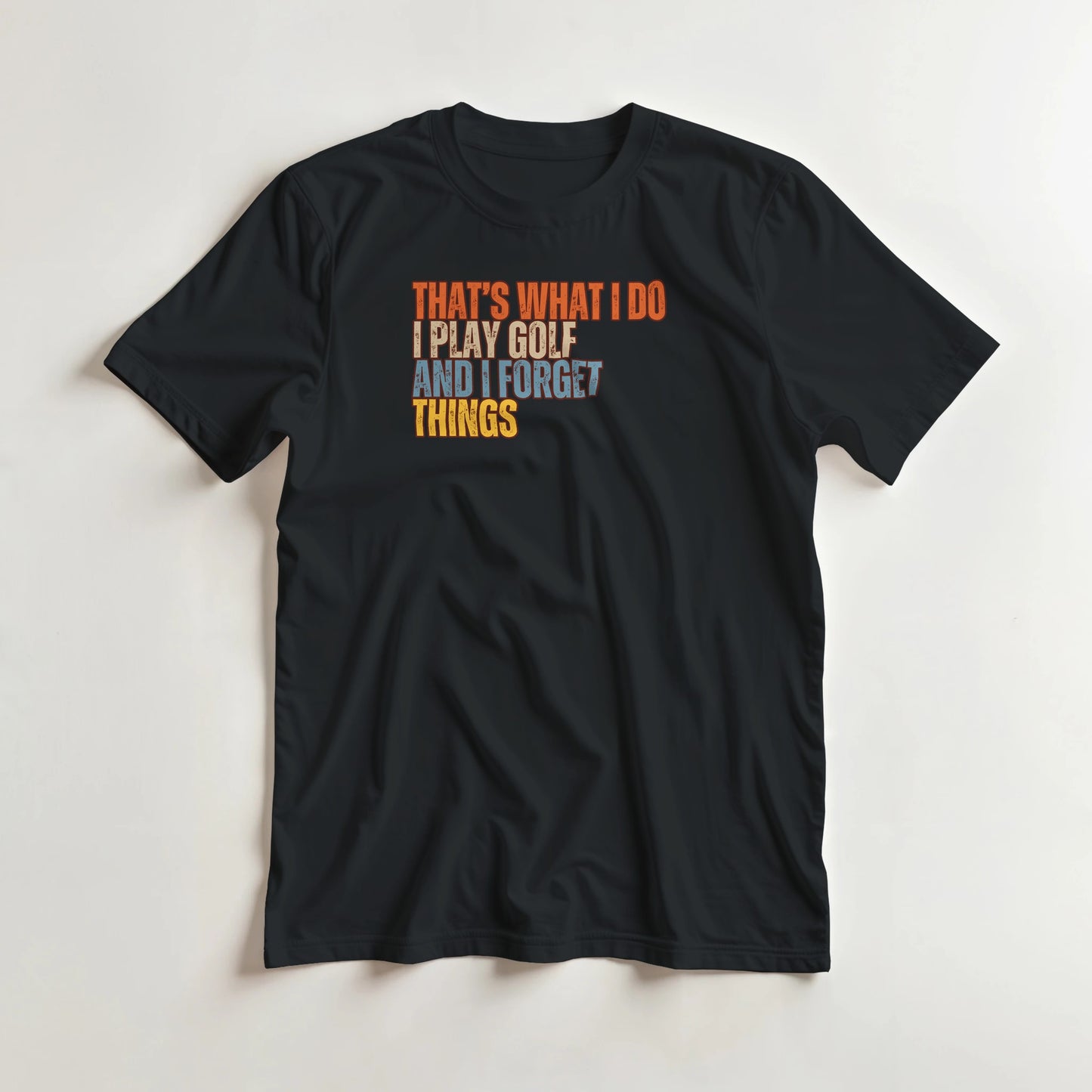 What I Do T-Shirt in Black lying on a plain floor. T-shirt is a unisex cut and 100 per cent cotton.
