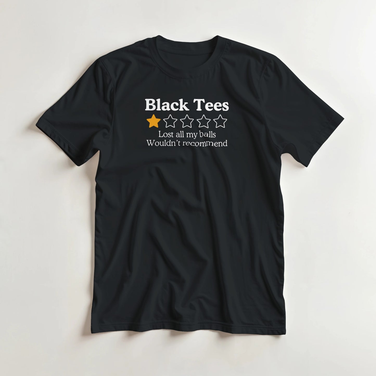 Black Tees T-Shirt in Black M lying on a plain floor. T-shirt is a unisex cut and 100 per cent cotton.