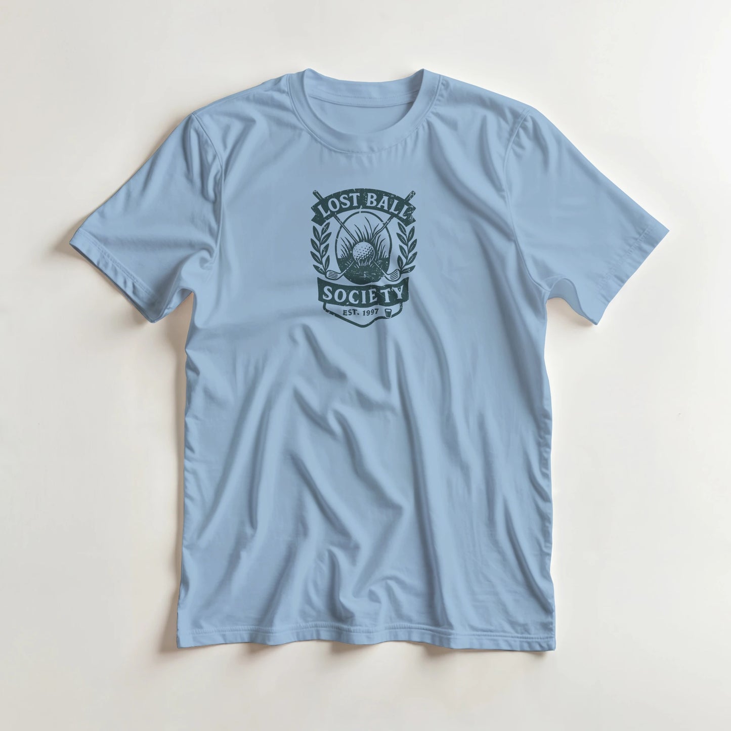 Lost Ball Society T-Shirt in Light Blue S lying on a plain floor. T-shirt is a unisex cut and 100 per cent cotton.