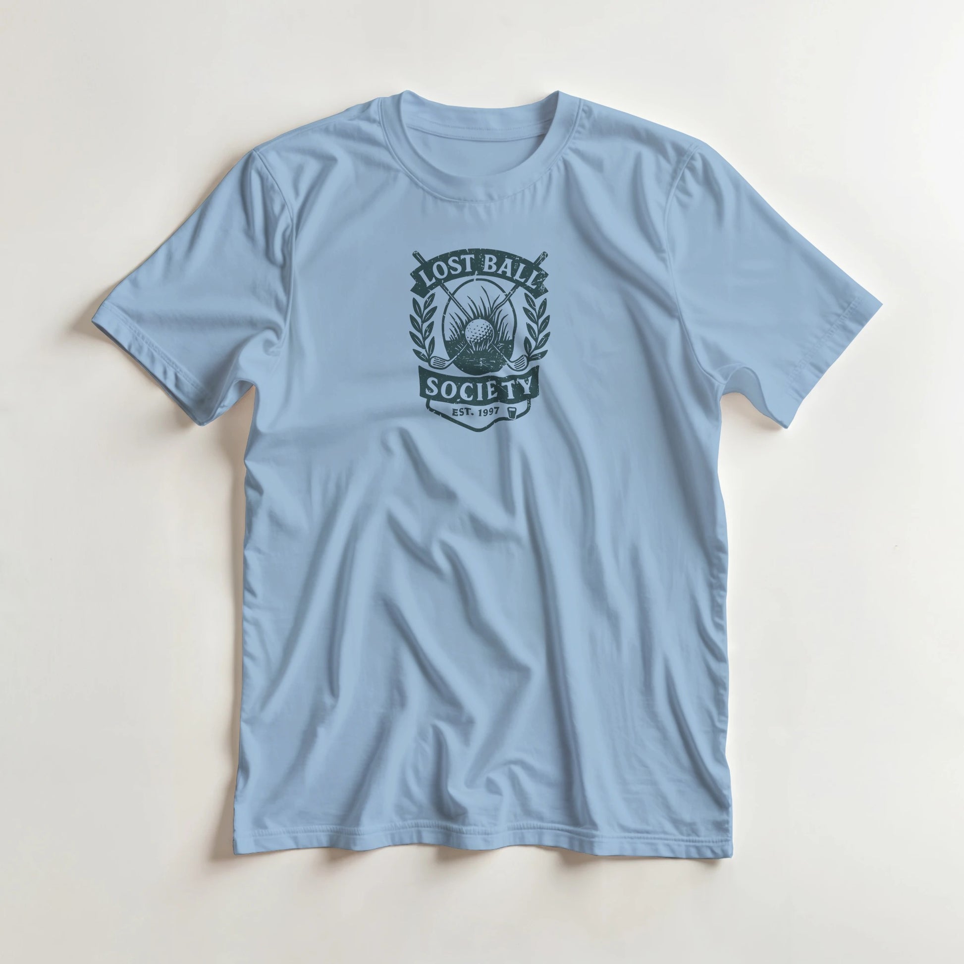 Lost Ball Society T-Shirt in Light Blue S lying on a plain floor. T-shirt is a unisex cut and 100 per cent cotton.