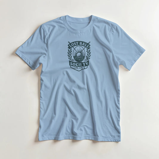 Lost Ball Society T-Shirt in Light Blue S lying on a plain floor. T-shirt is a unisex cut and 100 per cent cotton.