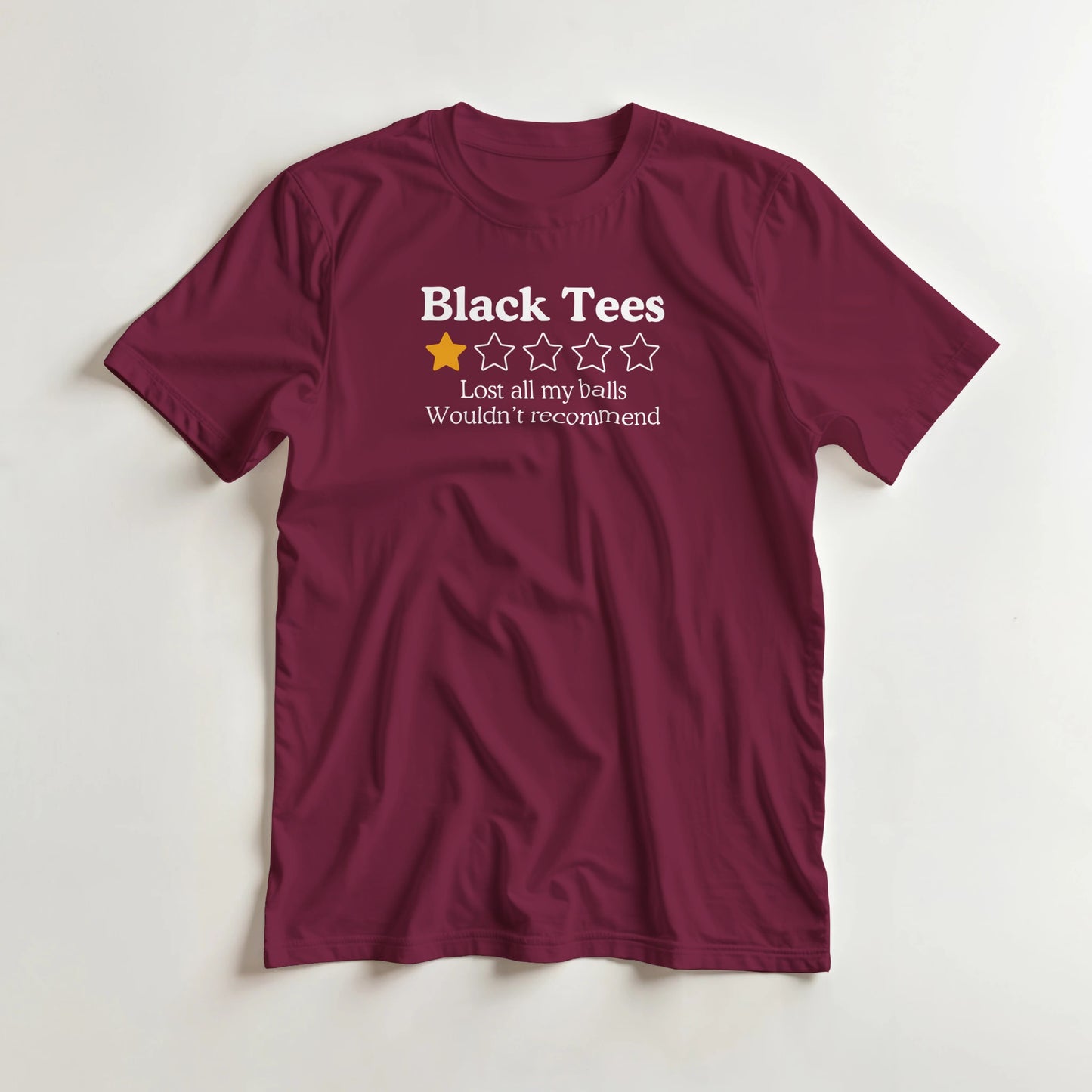 Black Tees T-Shirt in Maroon XL lying on a plain floor. T-shirt is a unisex cut and 100 per cent cotton.