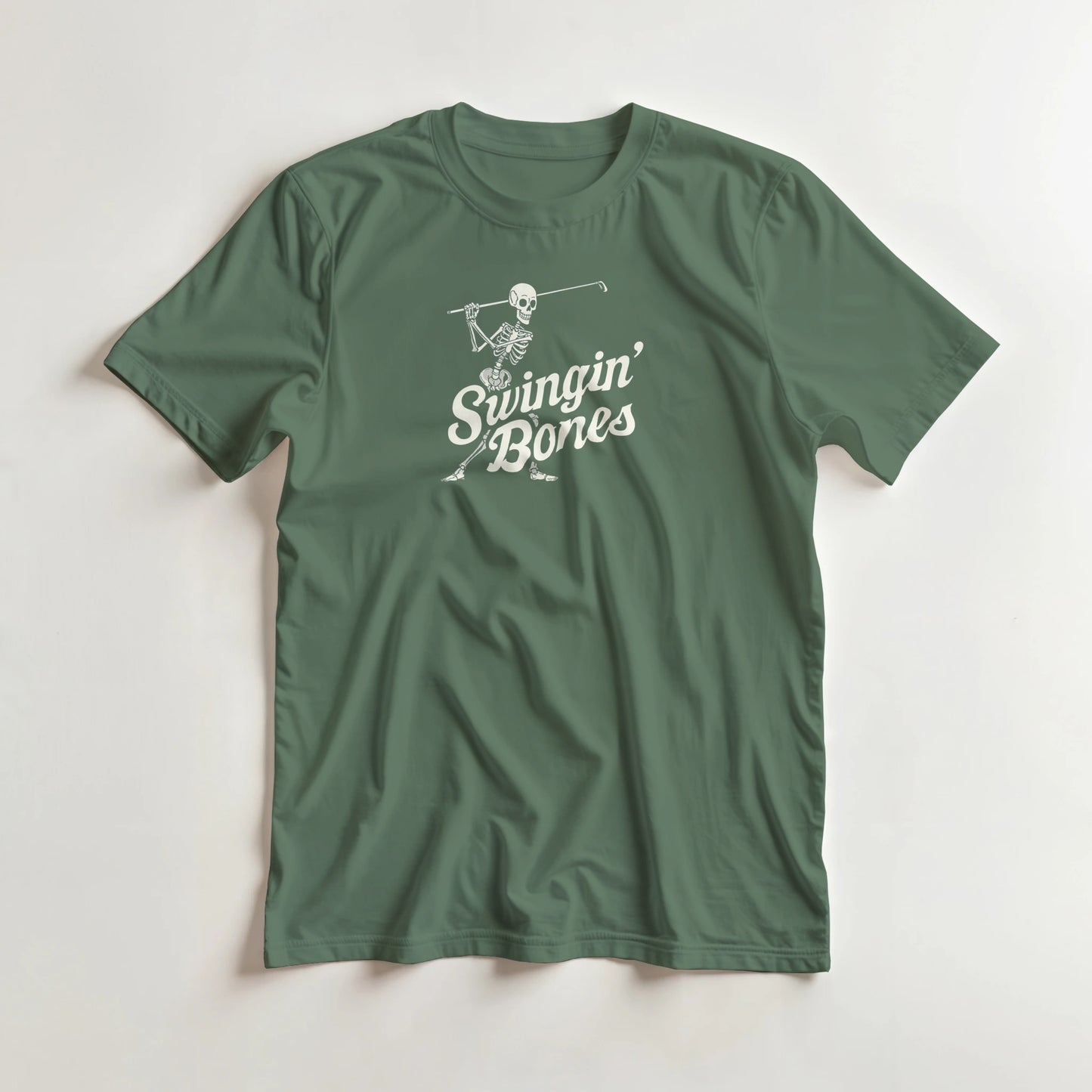 Swingin' Bones T-Shirt in Military Green L lying on a plain floor. T-shirt is a unisex cut and 100 per cent cotton.